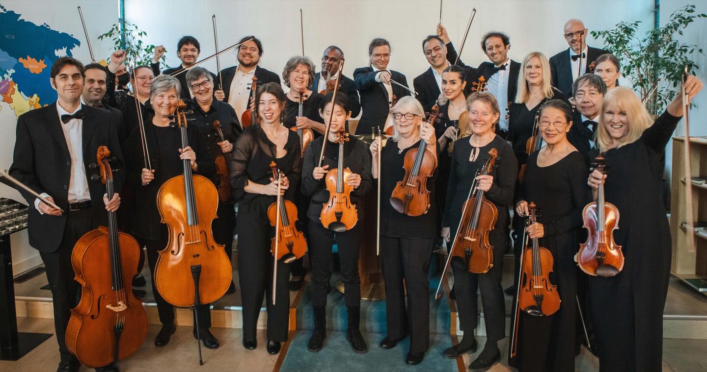 Orchestra musicians together after a performance